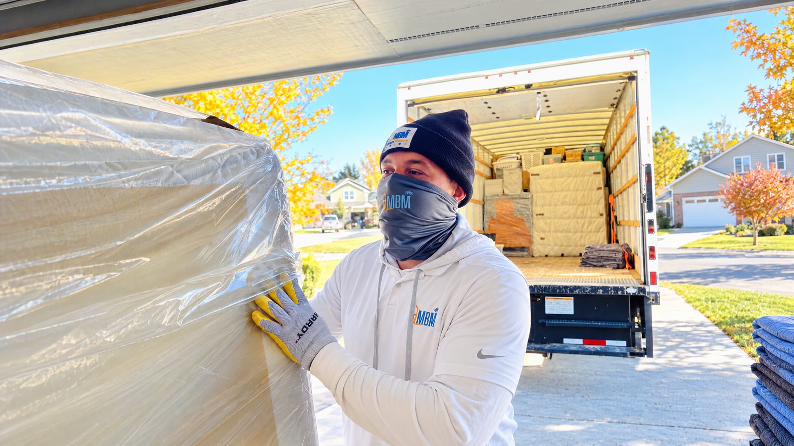 Mama Boy Movers professional protecting furniture outside a moving truck