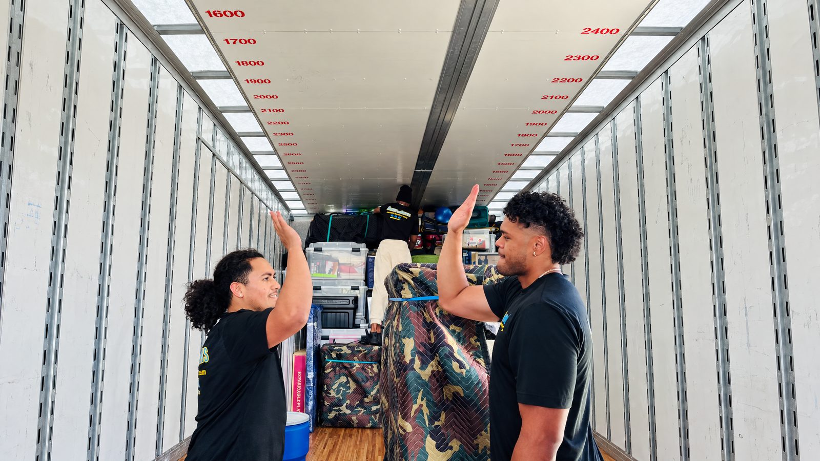 Mama Boy Movers crew organizing a safely loaded moving truck