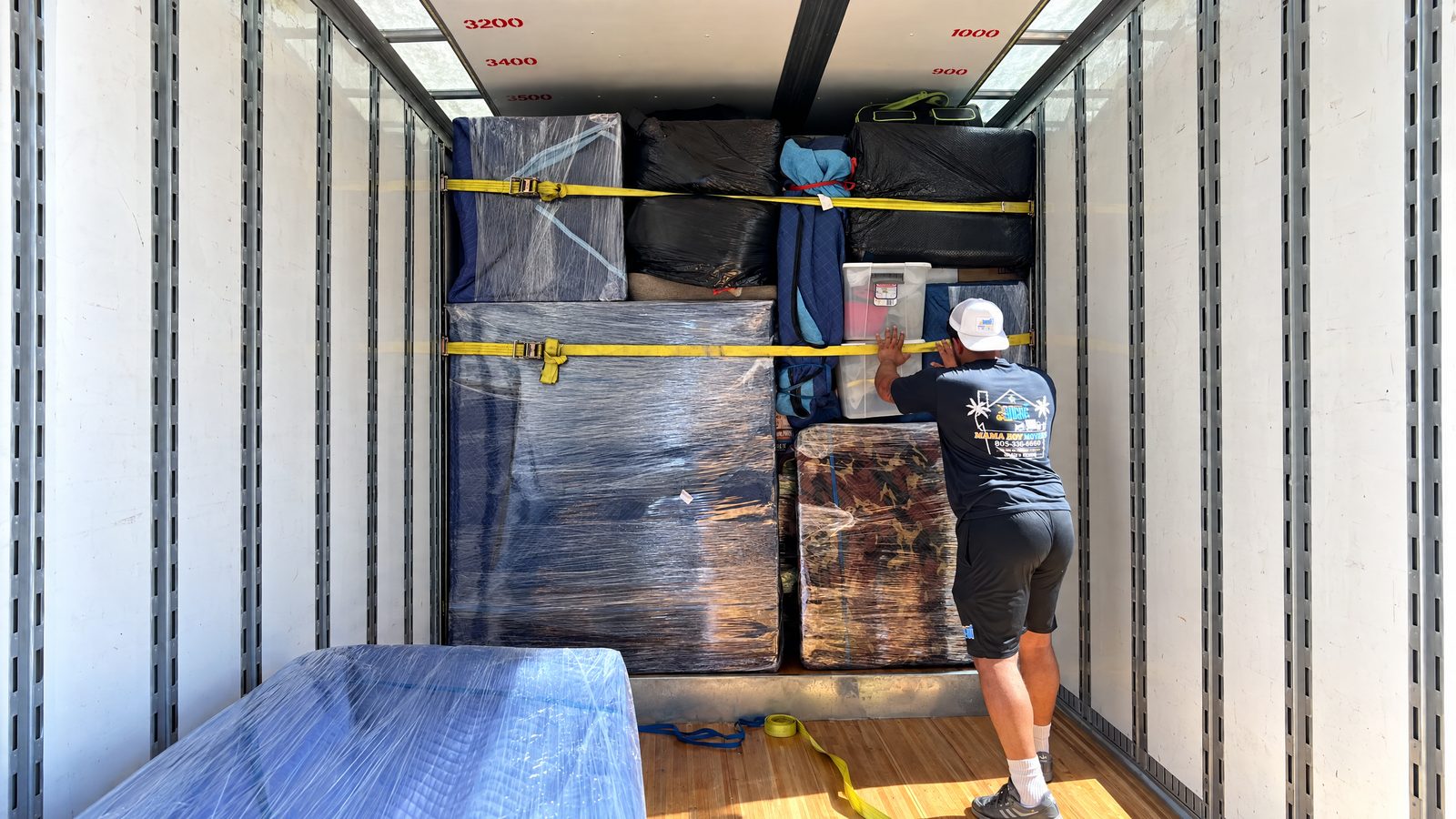 Securely loaded Mama Boy Movers truck interior prepared for long-distance moving